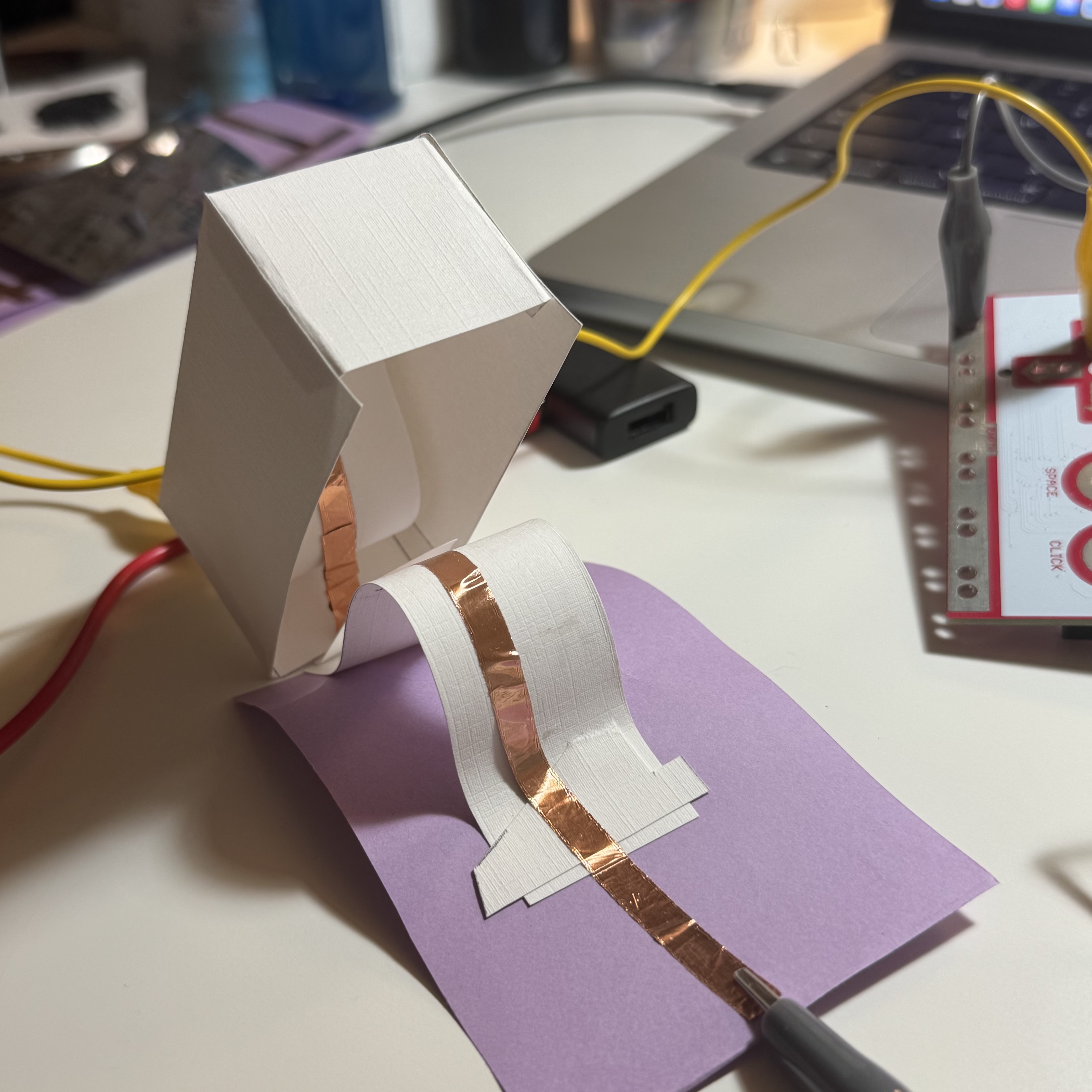 I made a switch with rebound effect. Once the box is pressed, the circuit will be closed.