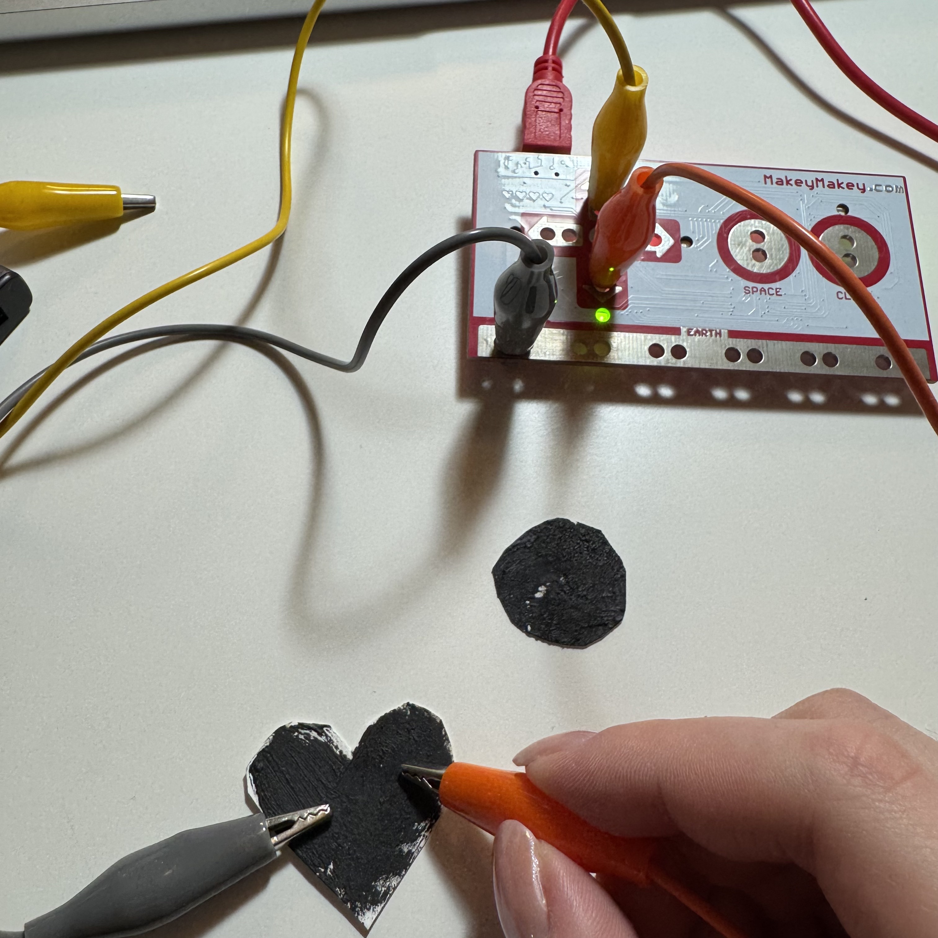 I put two alligator clips on Makey Makey and made them connected with two graphite buttons with different appearances